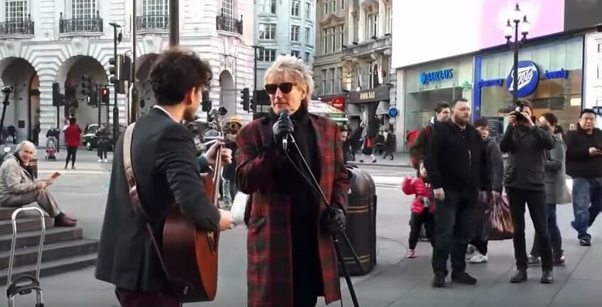 Star artist asks to borrow street musician’s microphone.