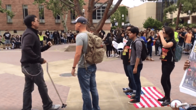Group of liberal punks stand on the American flag. Then a disabled veteran shows up..